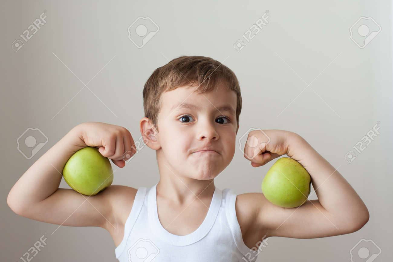 boy with green apples showing biceps face - 50131018 boy with green apples showing biceps face - 50131018
