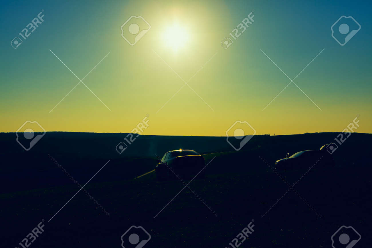 Silhouette of cars on the hill . Sundown over the country - 167986899 Silhouette of cars on the hill . Sundown over the country - 167986899