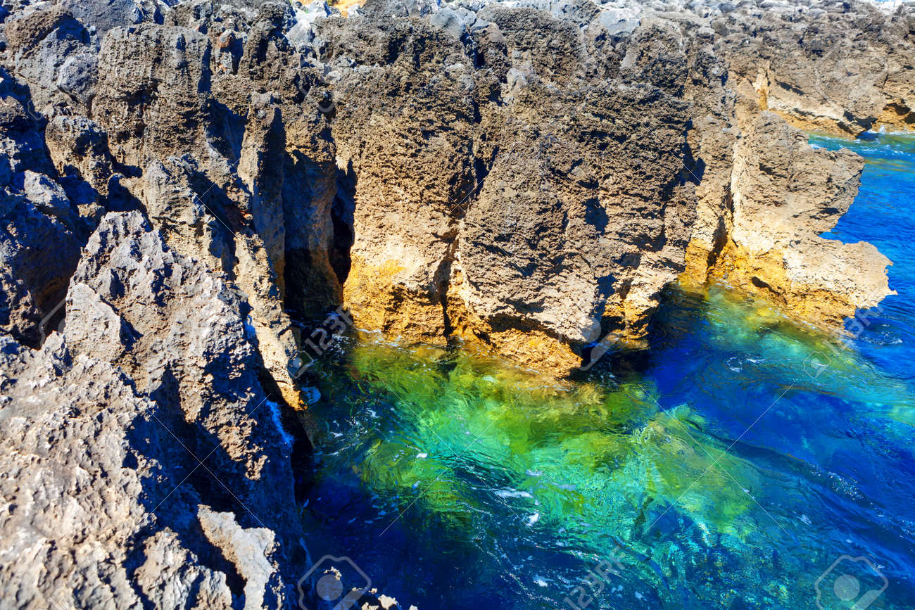 Coastal rock formation and ocean turquoise water . Tropical littoral . Oceanfront cliffs of Boca do Inferno - 170092780 Coastal rock formation and ocean turquoise water . Tropical littoral . Oceanfront cliffs of Boca do Inferno - 170092780