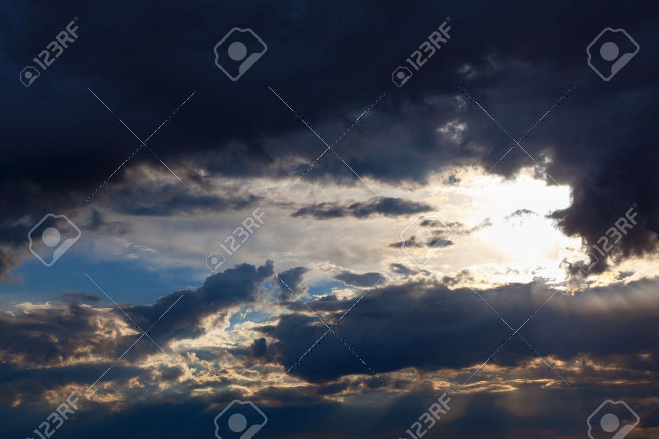 Sun shining through dark clouds . Sunlight rays and cloudy heaven - 169997071 Sun shining through dark clouds . Sunlight rays and cloudy heaven - 169997071