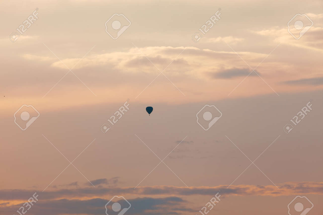 Evening sky with air balloon . Silhouette of hot air balloon flying during sunset, - 170080930 Evening sky with air balloon . Silhouette of hot air balloon flying during sunset, - 170080930