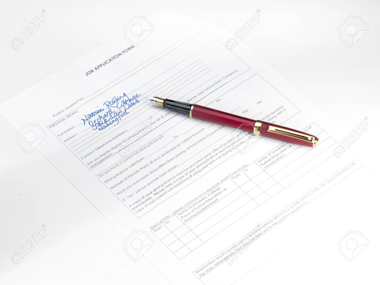 a fountain pen with partially filled out job application form stock filled out job application