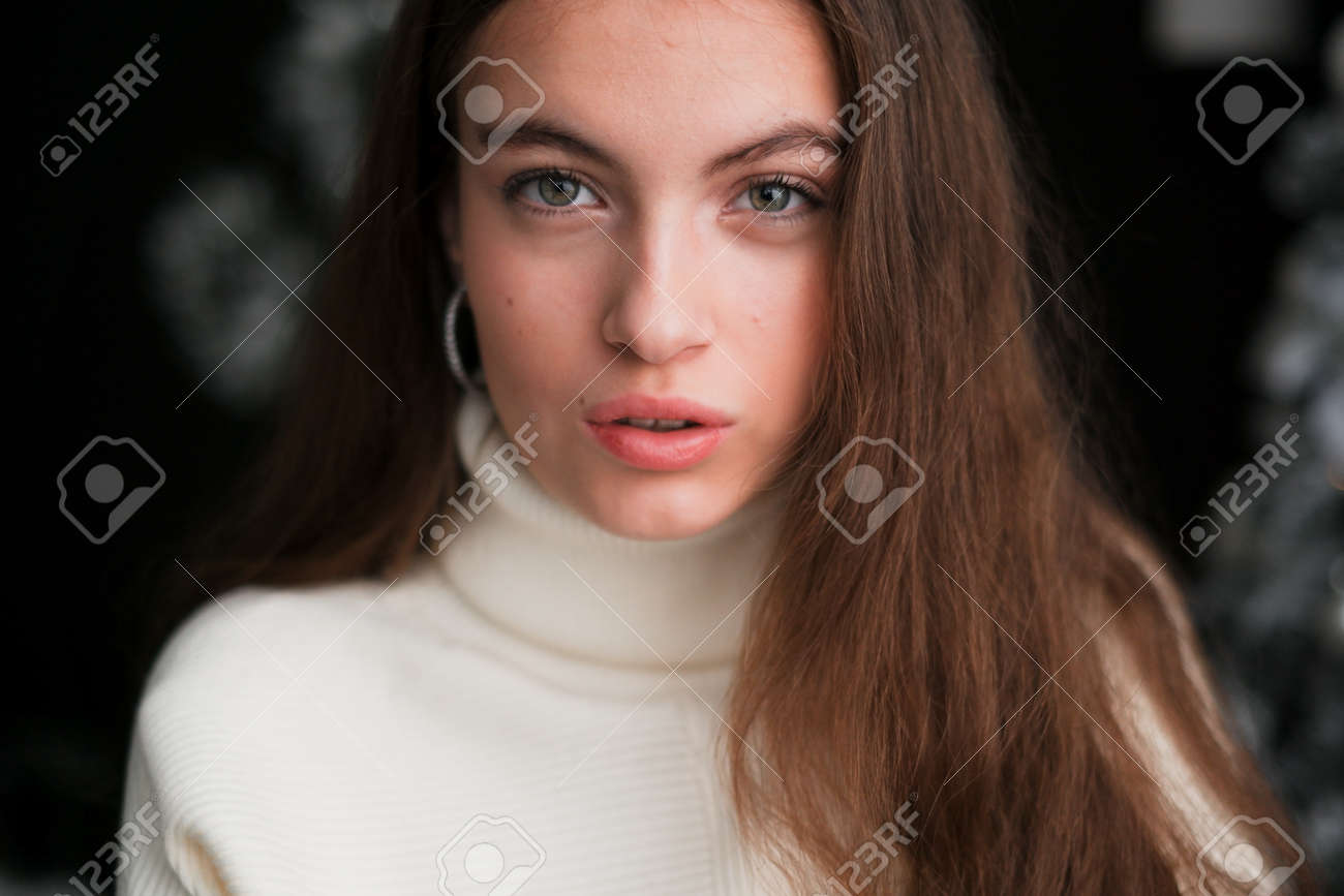 A Close-up Portrait Of A Beautiful Young Girl With Brown Hair And Green Eyes  With Natural Makeup In Light Clothing On A Light Background. Selective  Focus. Beauty And Skin Care Concept Stock, image size:1300x867