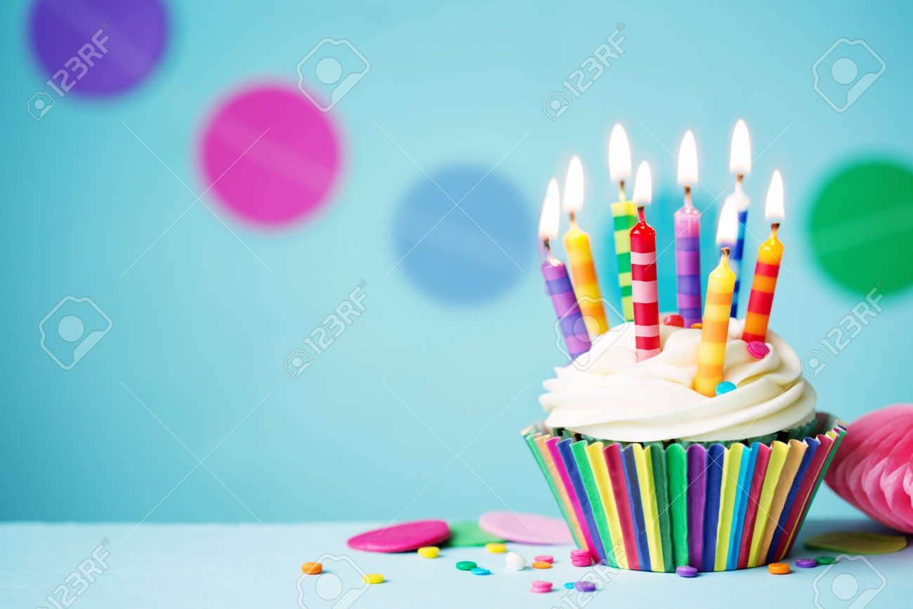 colorful birthday cupcake with single candle stock photo picture
