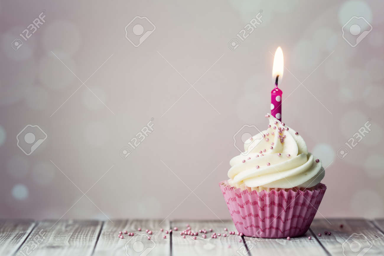 pink birthday cupcake with candle stock photo picture and royalty