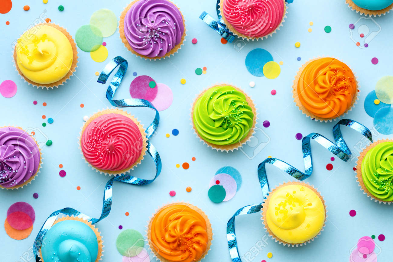 Colorful cupcake party background on blue - 57319396 Colorful cupcake party background on blue - 57319396