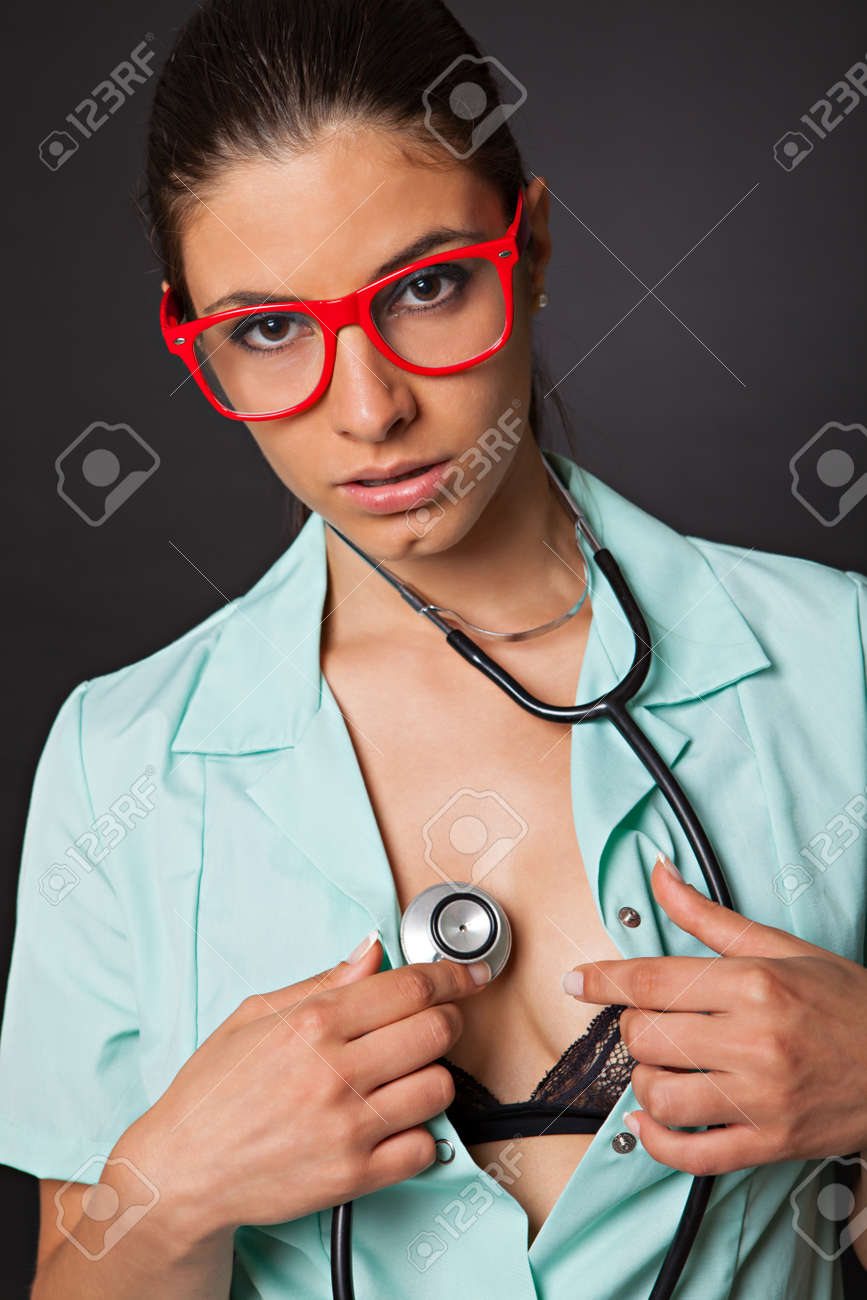 Sexy woman doctor with a stethoscope and glasses on black background - 45067799