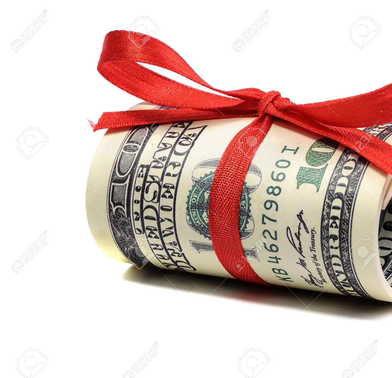 bundle of bills of one hundred dollars tied with a red ribbon