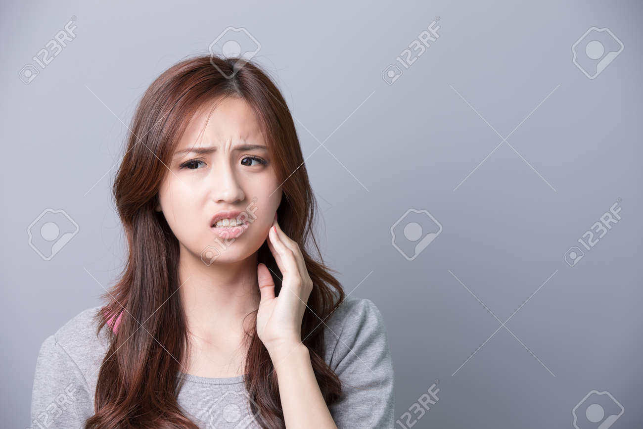 https://previews.123rf.com/images/ryanking999/ryanking9991603/ryanking999160300334/54087691-unhappy-woman-feel-pain-on-her-teeth-isolated-on-gray-background-asian-beauty.jpg