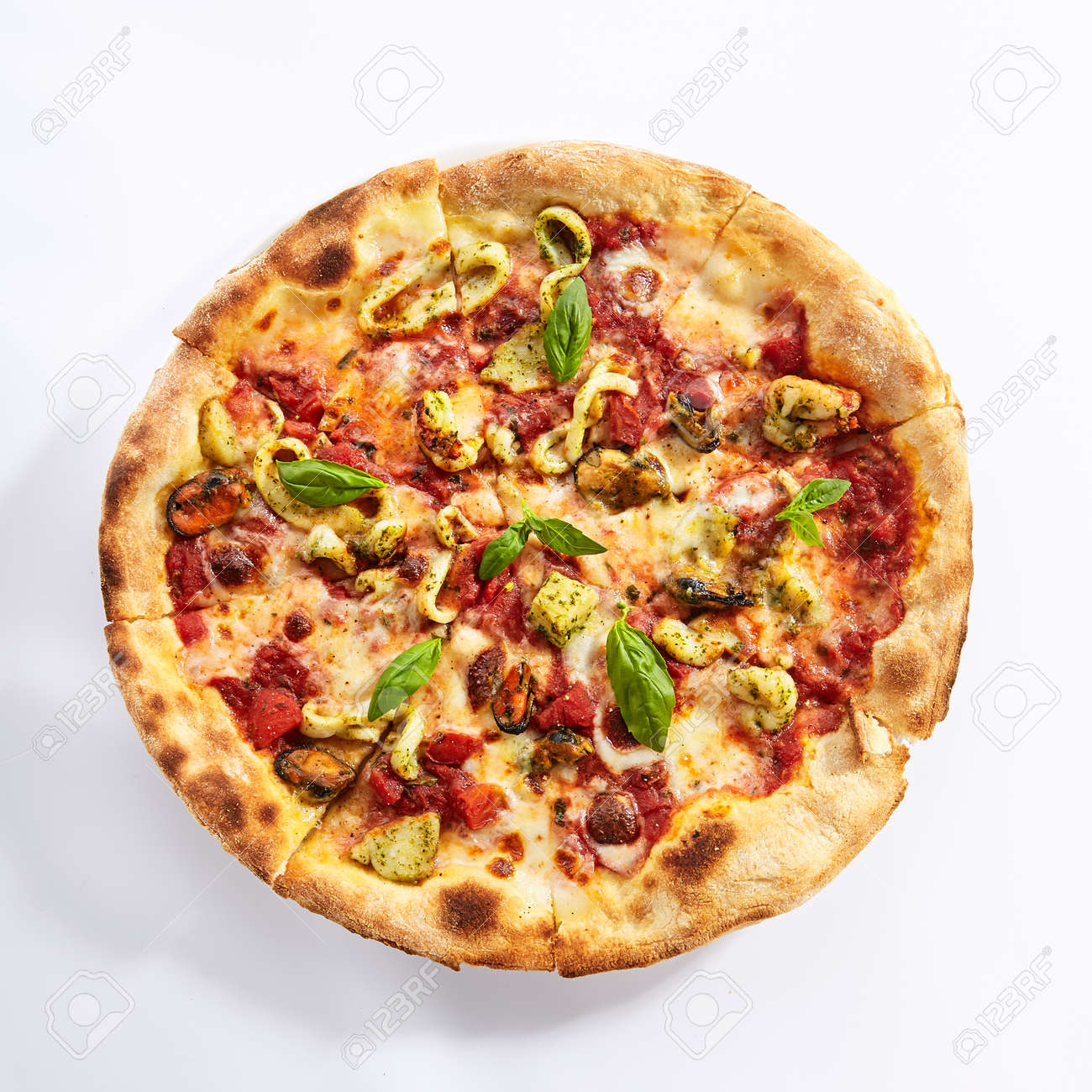 Seafood pizza top view. Sliced traditional Italian cuisine with squid and mussel meat. Pizzeria restaurant dish isolated on white background. Sea food ingredients on baked dough concept - 129169928 Seafood pizza top view. Sliced traditional Italian cuisine with squid and mussel meat. Pizzeria restaurant dish isolated on white background. Sea food ingredients on baked dough concept - 129169928