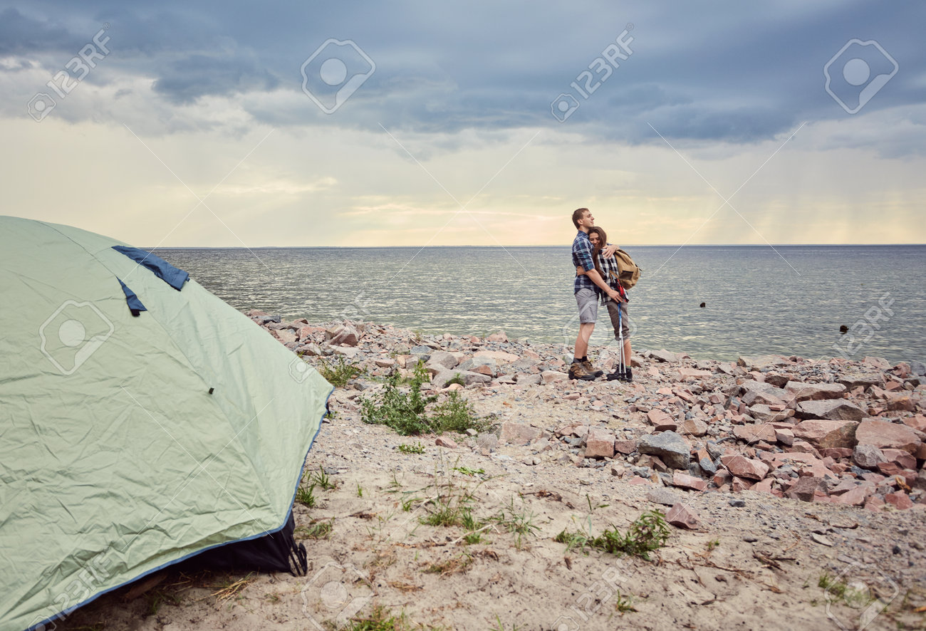 Happy couple with travel backpacks enjoying their summer vacation trip - 170687720 Happy couple with travel backpacks enjoying their summer vacation trip - 170687720