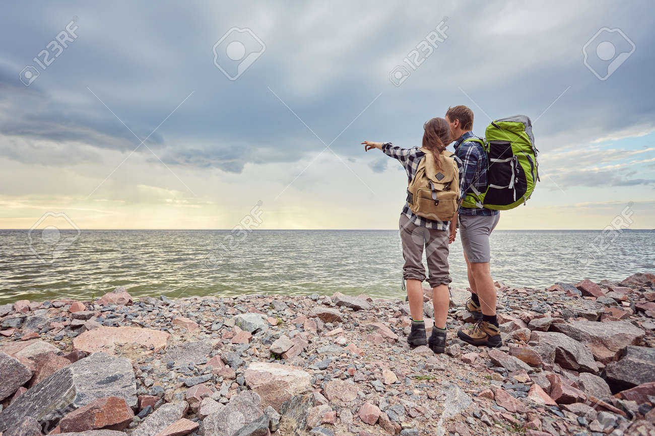 adventure, travel, tourism, hike and people concept - smiling couple with backpacks outdoors - 170687723 adventure, travel, tourism, hike and people concept - smiling couple with backpacks outdoors - 170687723