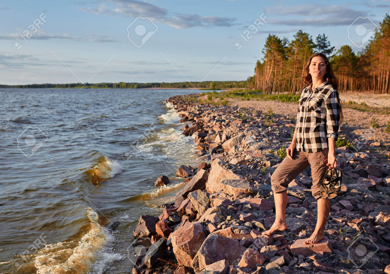 Young woman walking along Great Salt Lake beach. Landscape with people and copy space. - 170687706 Young woman walking along Great Salt Lake beach. Landscape with people and copy space. - 170687706