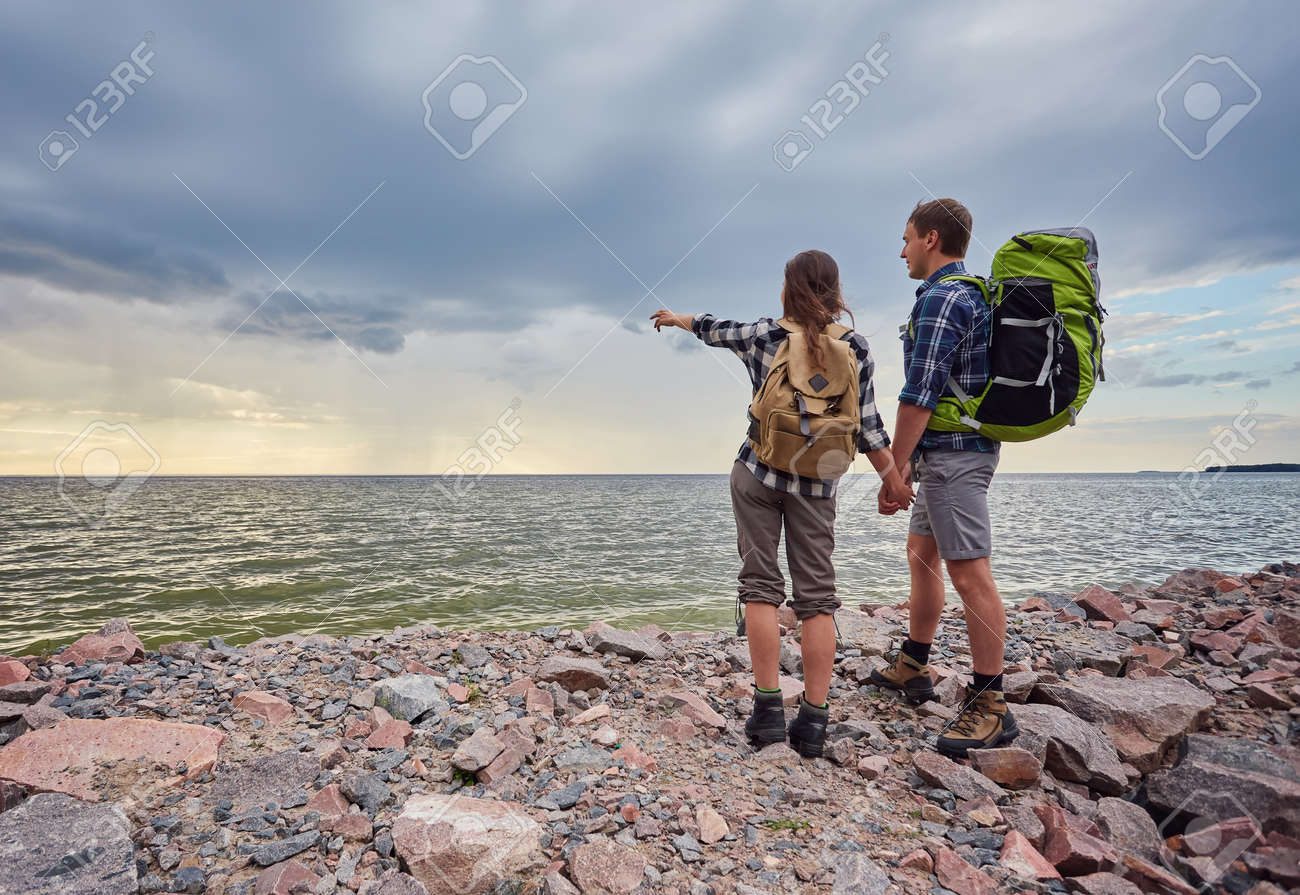 adventure, travel, tourism, hike and people concept - smiling couple with backpacks outdoors - 169020918 adventure, travel, tourism, hike and people concept - smiling couple with backpacks outdoors - 169020918