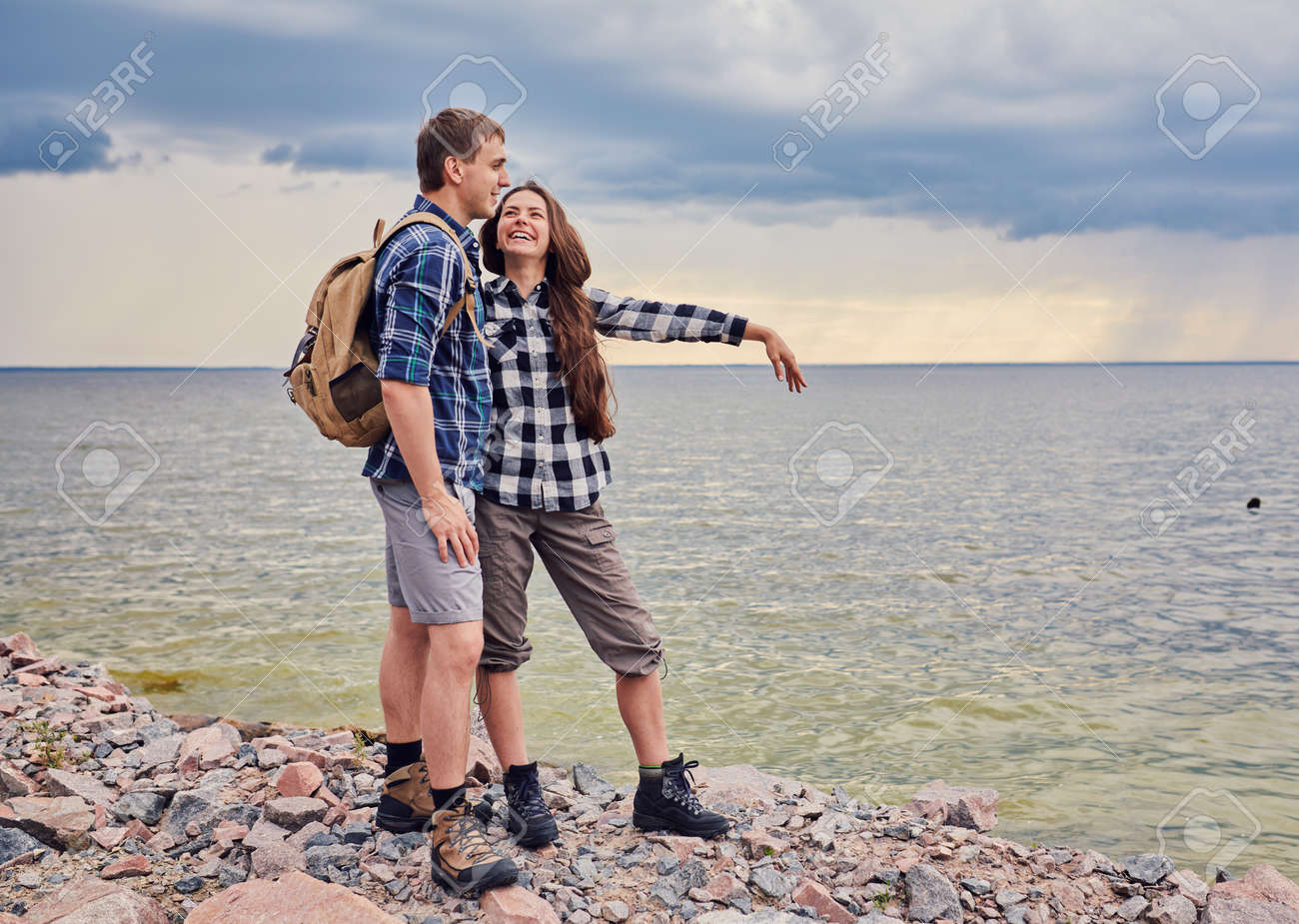 adventure, travel, tourism, hike and people concept - smiling couple with backpacks outdoors - 169021068 adventure, travel, tourism, hike and people concept - smiling couple with backpacks outdoors - 169021068