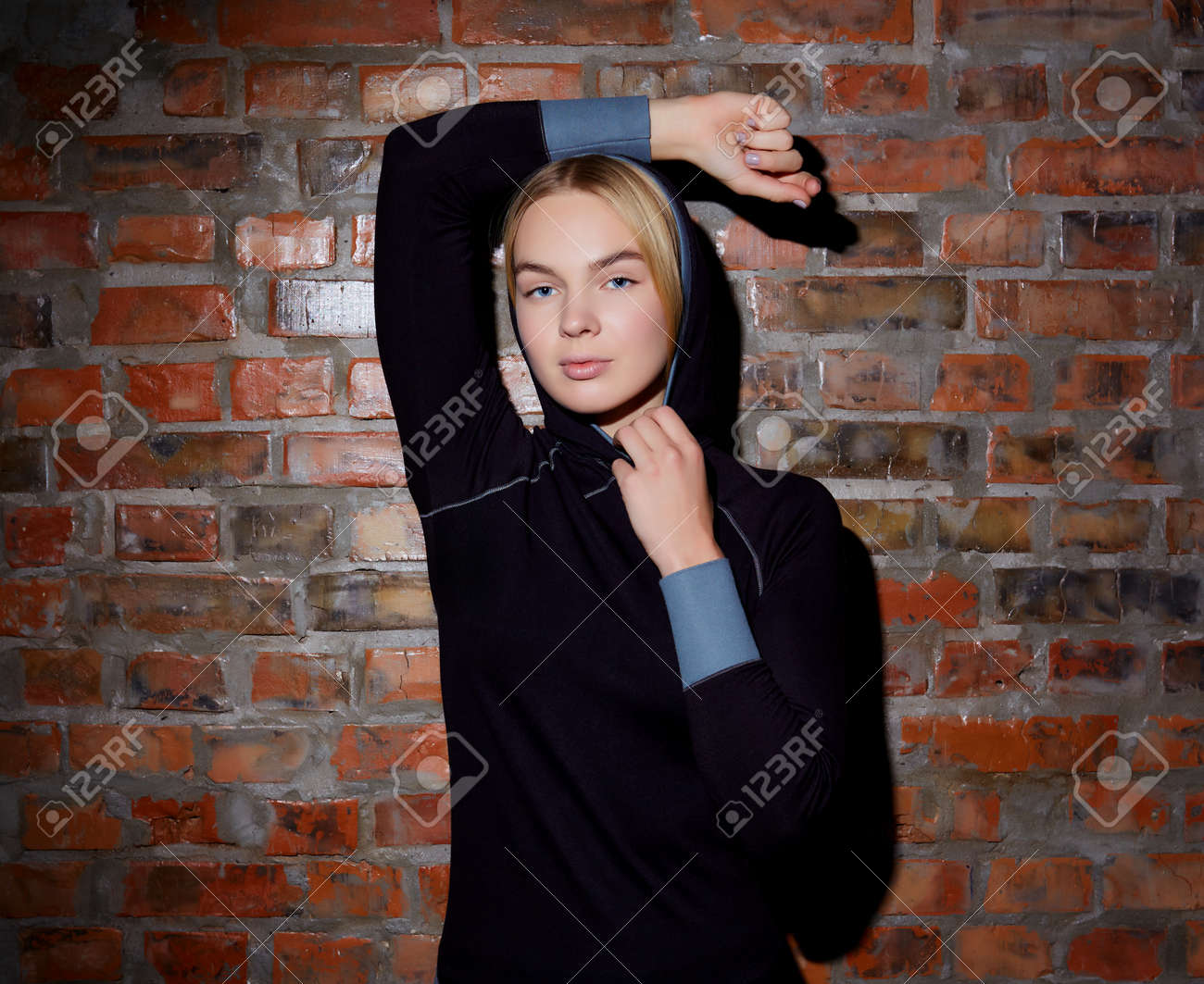 sport and yoga lifestyle concept. Young fit pretty woman dressed in sport clothes poses against brick wall. - 169021324 sport and yoga lifestyle concept. Young fit pretty woman dressed in sport clothes poses against brick wall. - 169021324