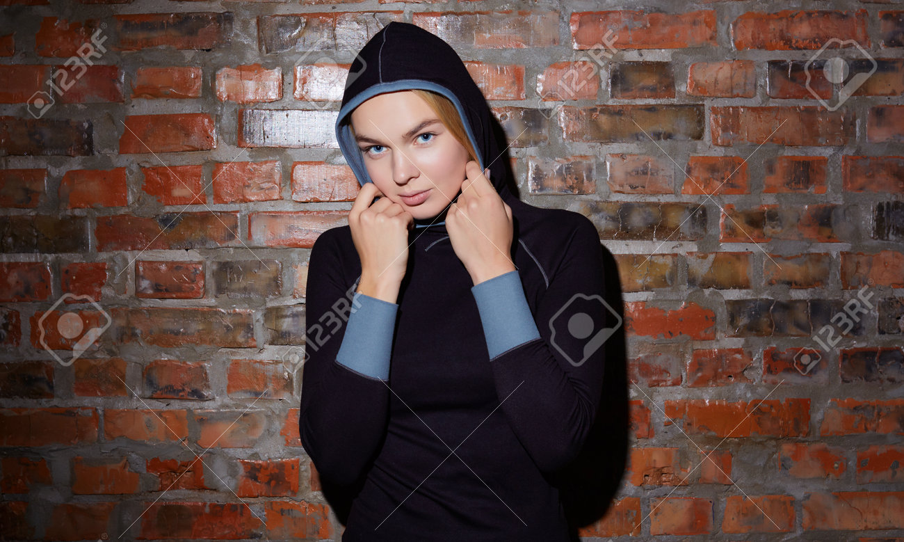 sport and yoga lifestyle concept. Young fit pretty woman dressed in sport clothes poses against brick wall. - 169021336 sport and yoga lifestyle concept. Young fit pretty woman dressed in sport clothes poses against brick wall. - 169021336