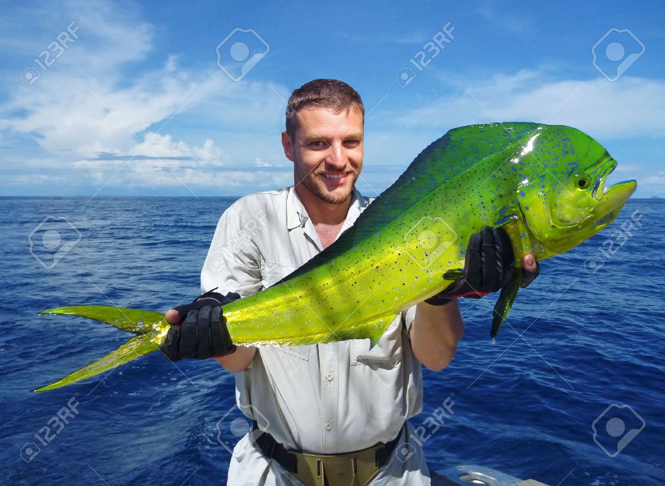 Deep Sea Fishing, Catch Of Fish, Fisherman Holding A Massive Dolphin Fish  Stock Photo, Picture and Royalty Free Image. Image 38987500.