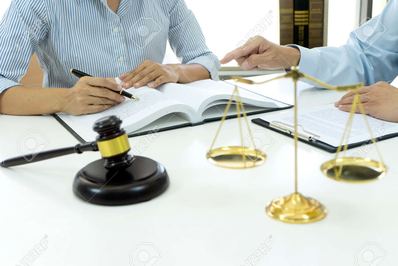 Lawyers and assistants are discussing legal matters to prepare business contracts and client solutions gavel and balance in the law firm - 169229750 Lawyers and assistants are discussing legal matters to prepare business contracts and client solutions gavel and balance in the law firm - 169229750