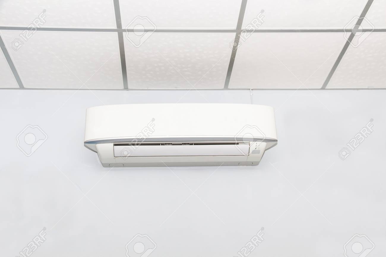 air conditioner on wall background in white room conditioning stock