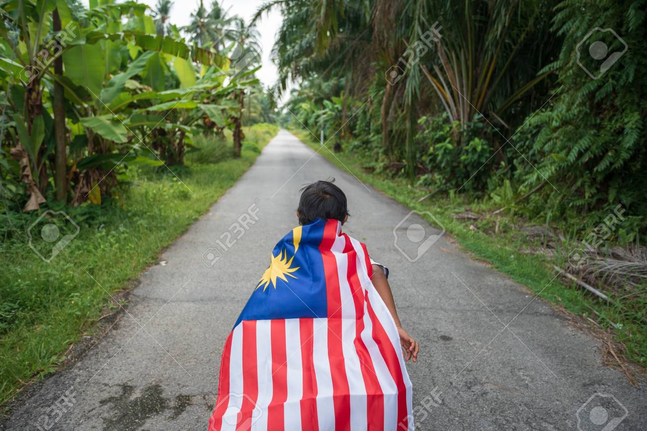Joyful Young Boy With Malaysia Flag In Nature Background. Merdeka
