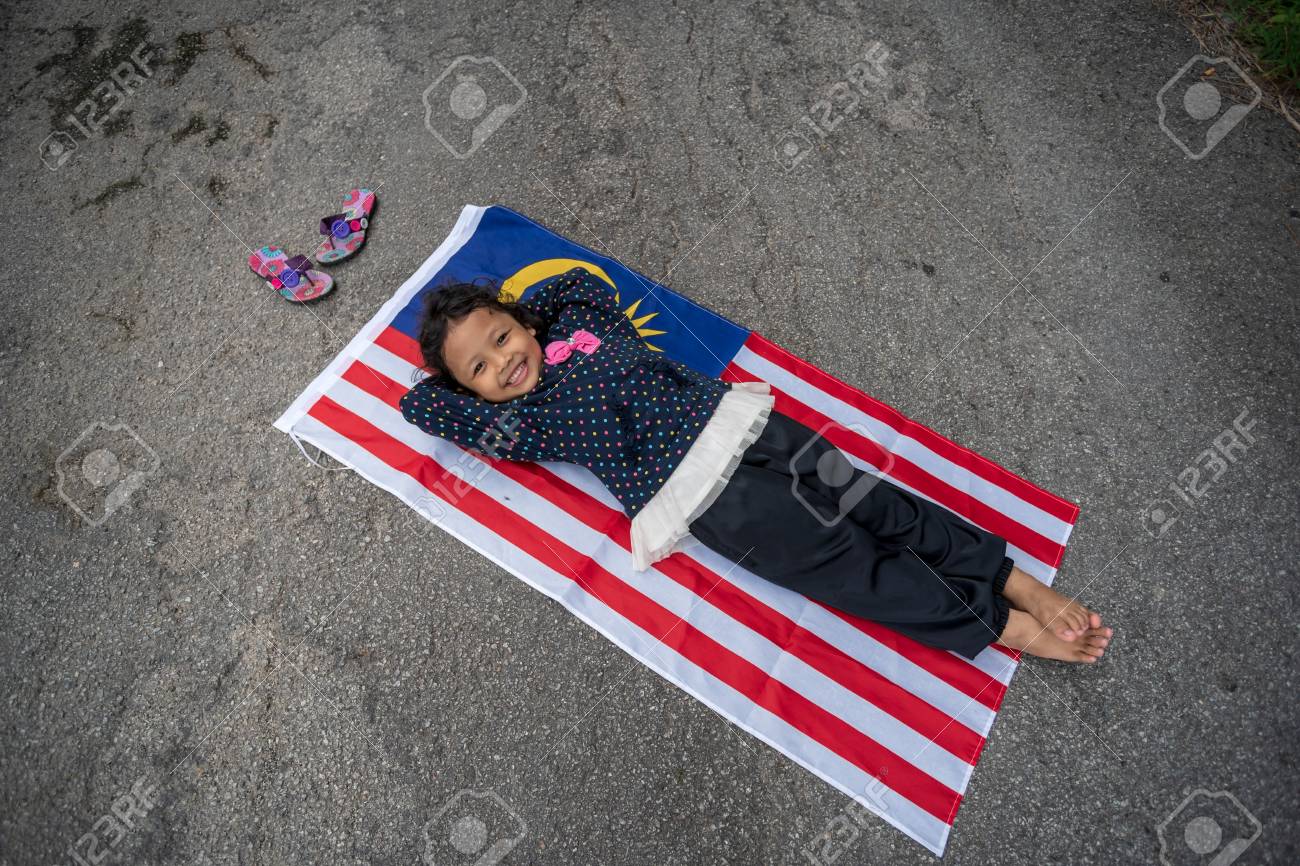 Cute Young Girl Lay On Malaysia Flag With Smile Merdeka Independence Day Theme Cute Young Girl Lay On Malaysia Flag With Smile Merdeka Independence Day Theme