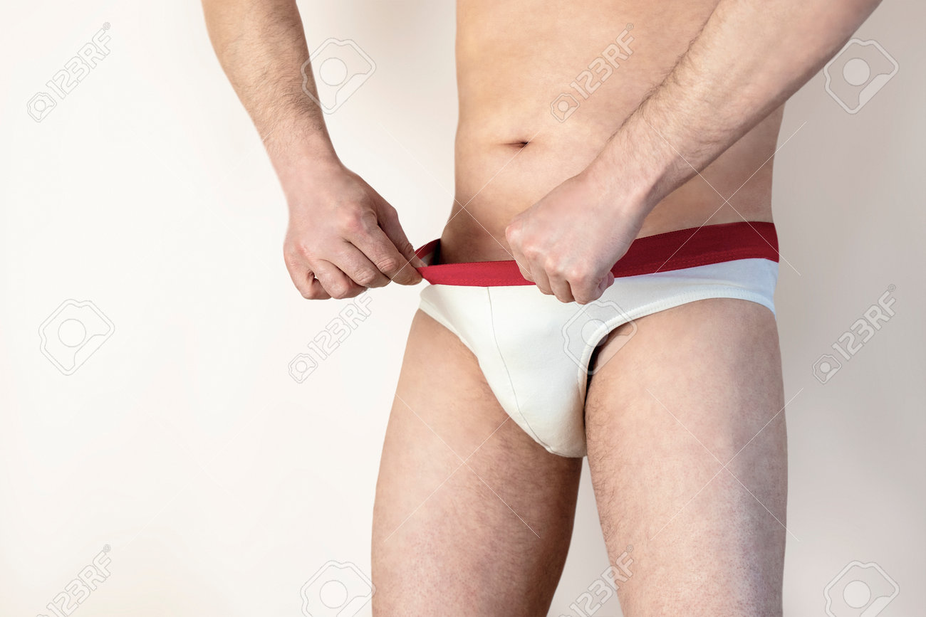 The Man Looks Into His Panties. Erection Problems. The Man Looks At His  Genitals. Isolated White Background Stock Photo, Picture and Royalty Free  Image. Image 167670974.