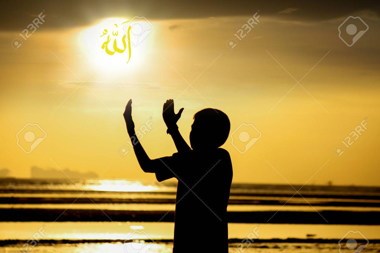 silhouette boy praying to allah on the beach at sunset arabic