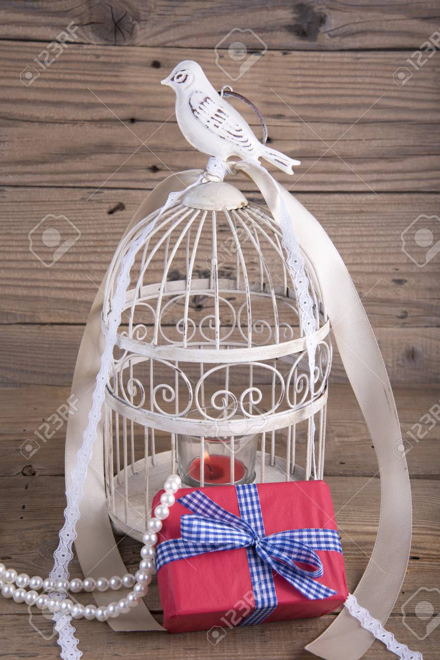 Bird Cage And Gift Box On Old Wooden Table Stock Photo Picture