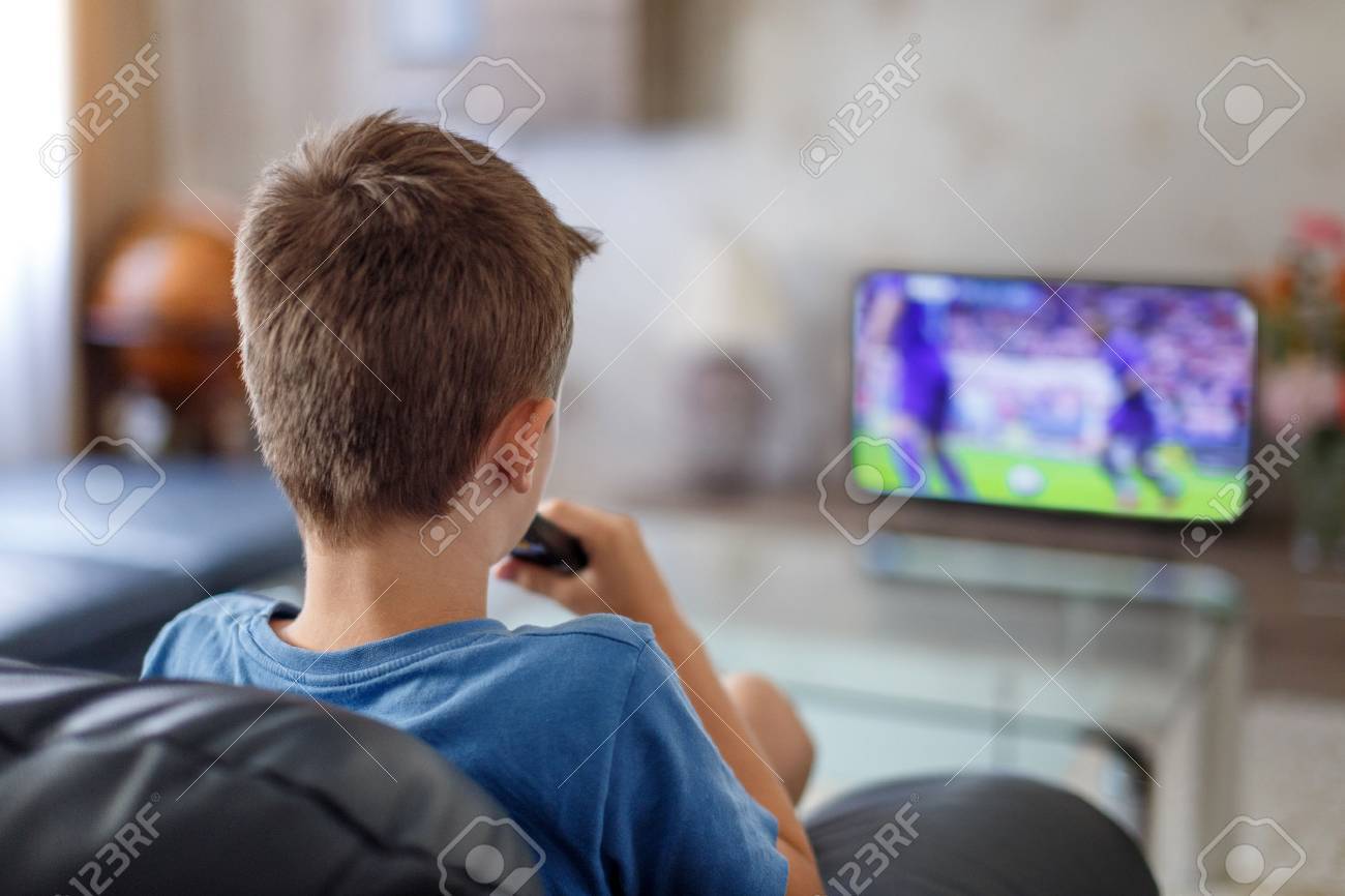 Excited little kid watching soccer match in TV at home - 59792998 Excited little kid watching soccer match in TV at home - 59792998