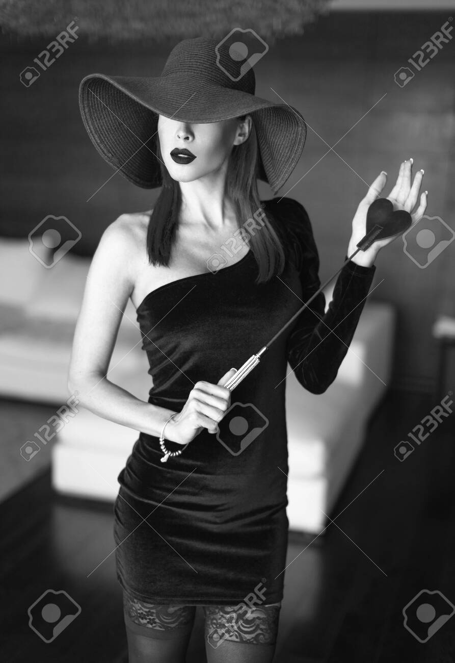 Passionate Dominant Femme Fatale In Hat With Whip Posing In Luxury Hotel,  Black And White Stock Photo, Picture and Royalty Free Image. Image  128278929., image size:893x1300