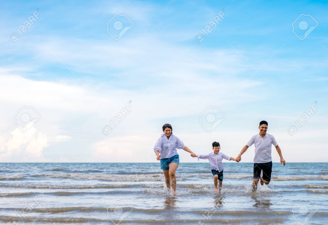 Portrait Happy Family Mom Dad And Son Playing Together In Beach