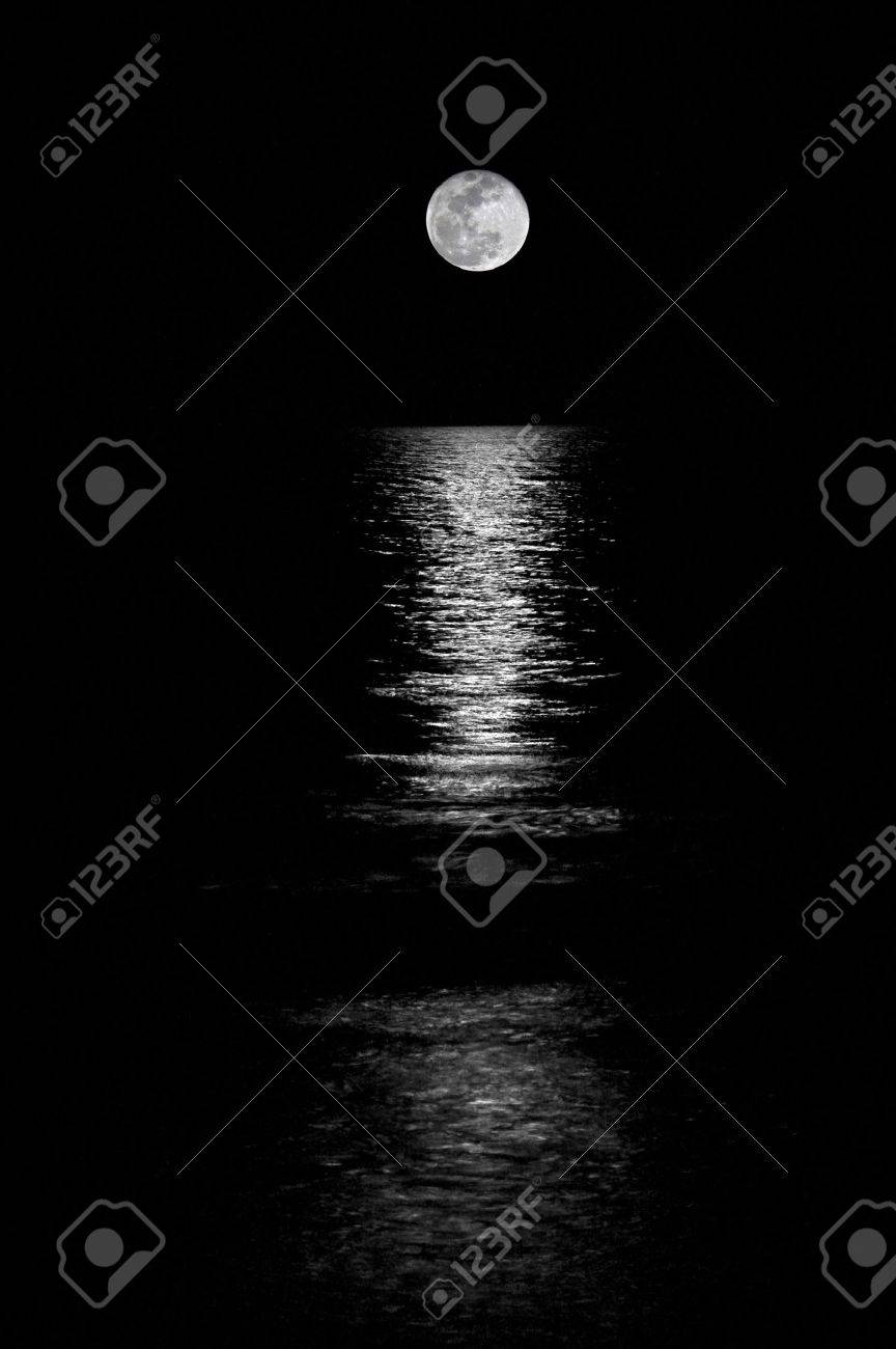 Full Moon Setting On The Horizon In The Ocean With Reflection Stock Photo Picture And Royalty Free Image Image 7544569