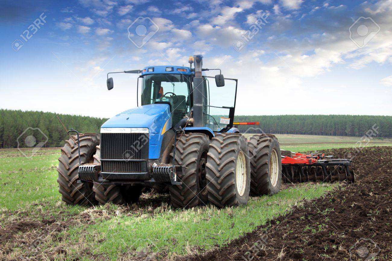 agricultural work plowing land on a powerful tractor - 18436382 agricultural work plowing land on a powerful tractor - 18436382