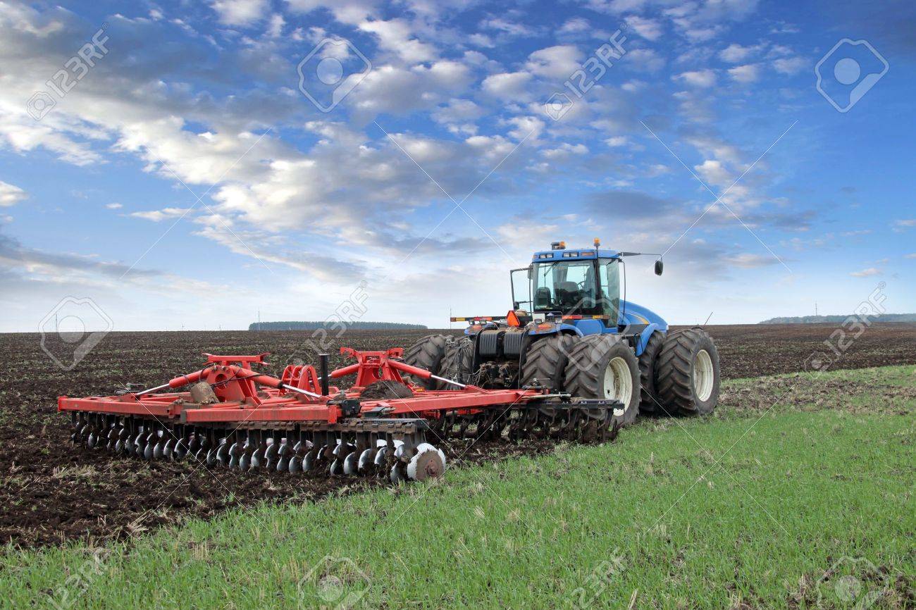 agricultural work plowing land on a powerful tractor - 19856209 agricultural work plowing land on a powerful tractor - 19856209