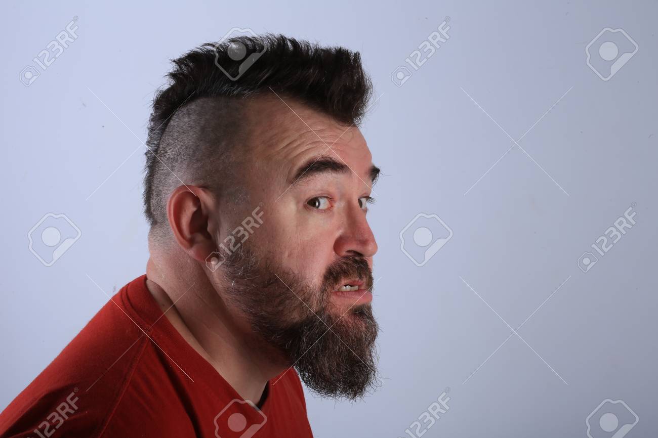 Close Up Portrait Profile Of A White Man With Mohawk And Beard