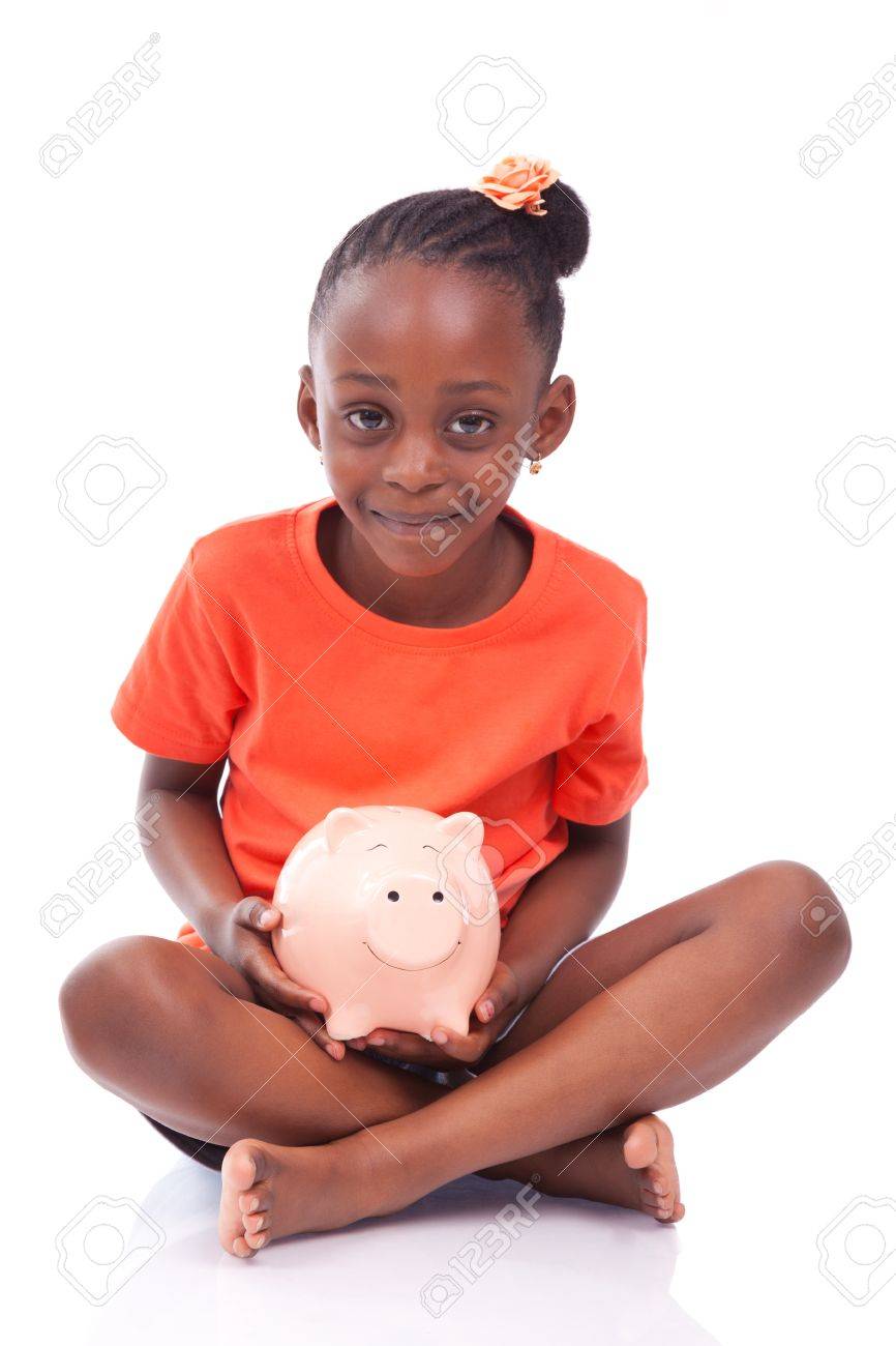 Cute little black girl holding a smiling piggy bank isolated on white background african