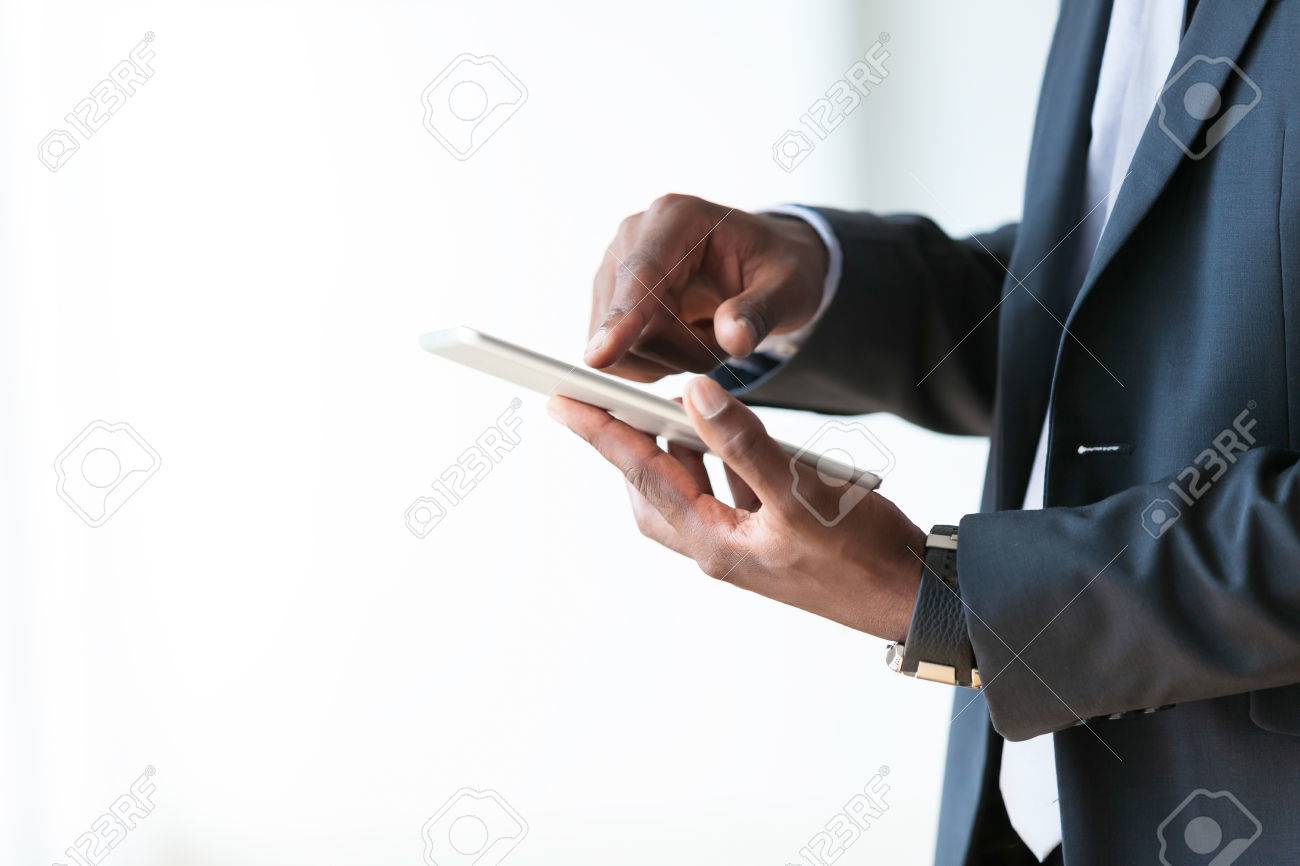 African american business man using a tactile tablet over white background - Black people - 43561640 African american business man using a tactile tablet over white background - Black people - 43561640