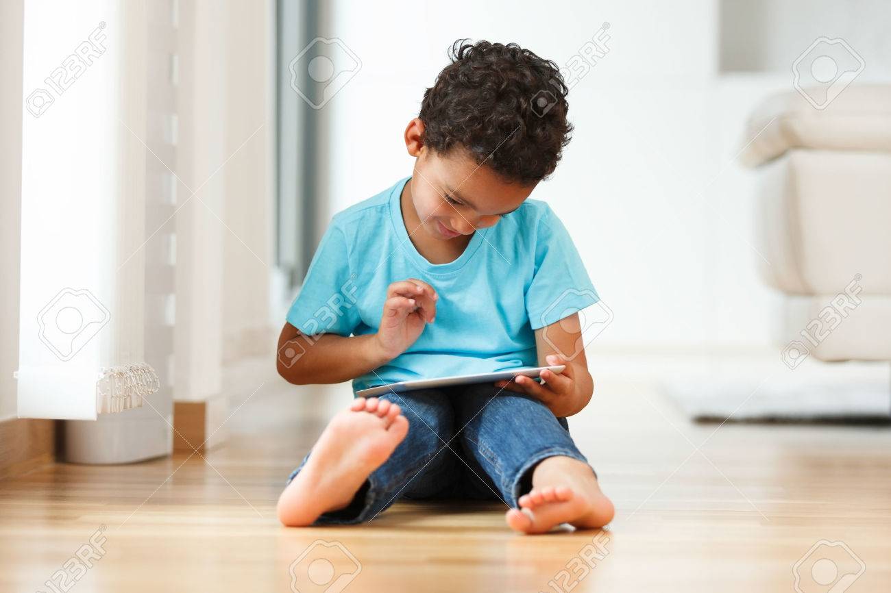 African american little boy using a tactile tablet - 45736502 African american little boy using a tactile tablet - 45736502