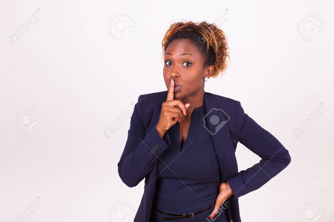 African American business woman making silence gesture with her finger - 47855426 African American business woman making silence gesture with her finger - 47855426