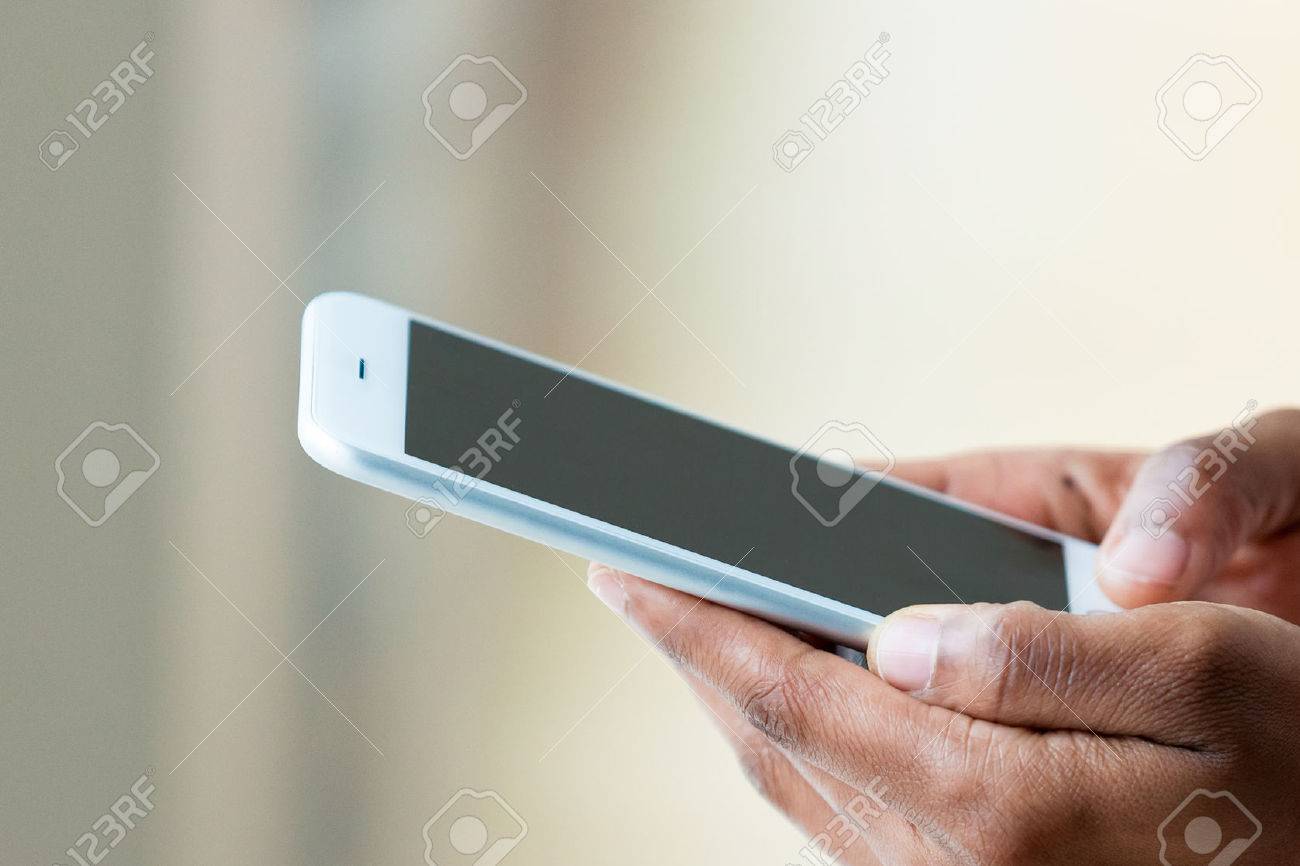 African american person holding a tactile mobile smartphone - Black people - 51547385 African american person holding a tactile mobile smartphone - Black people - 51547385