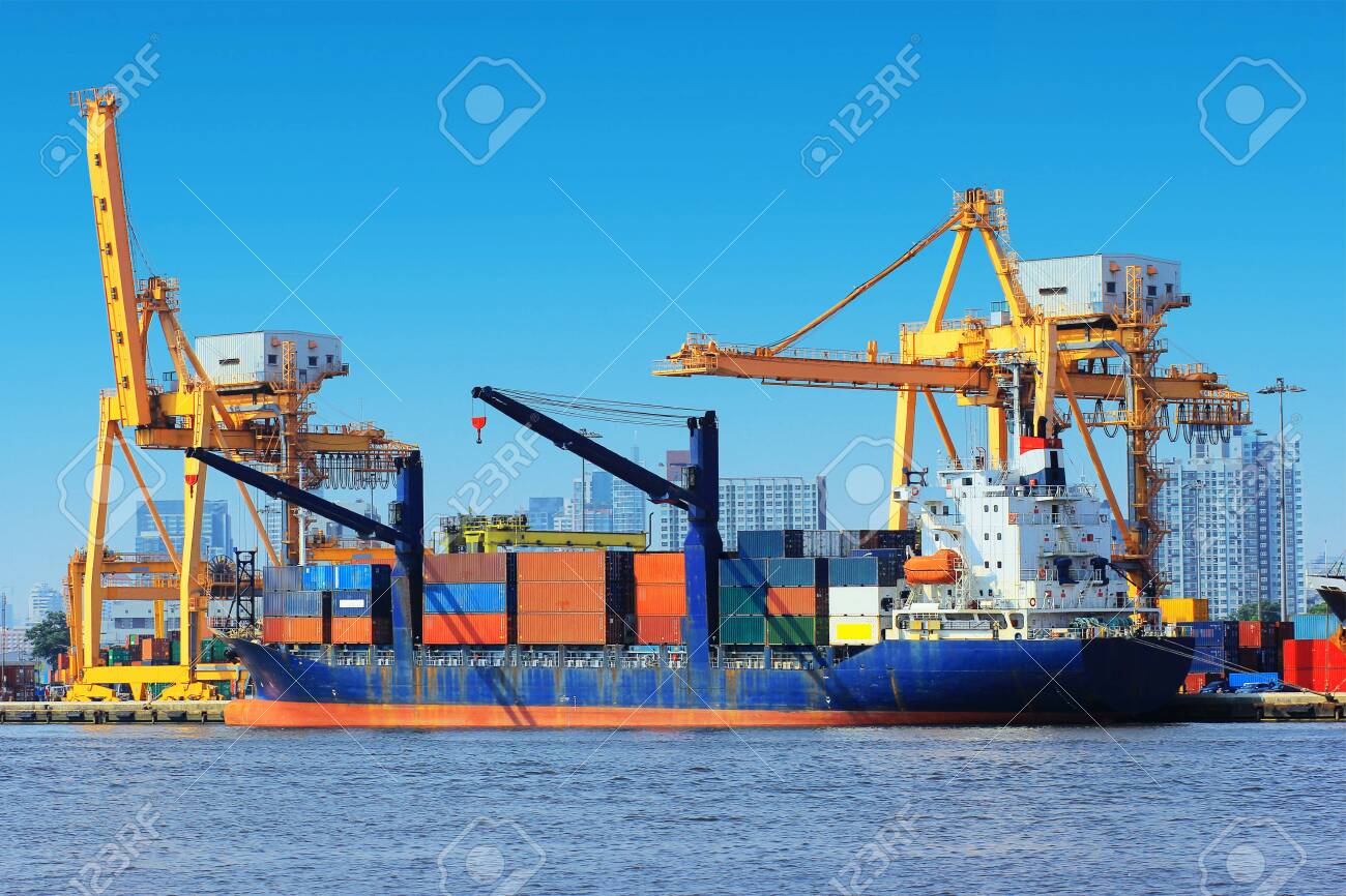 Container Cargo freight ship with working crane bridge in shipyard. - 123288644 Container Cargo freight ship with working crane bridge in shipyard. - 123288644