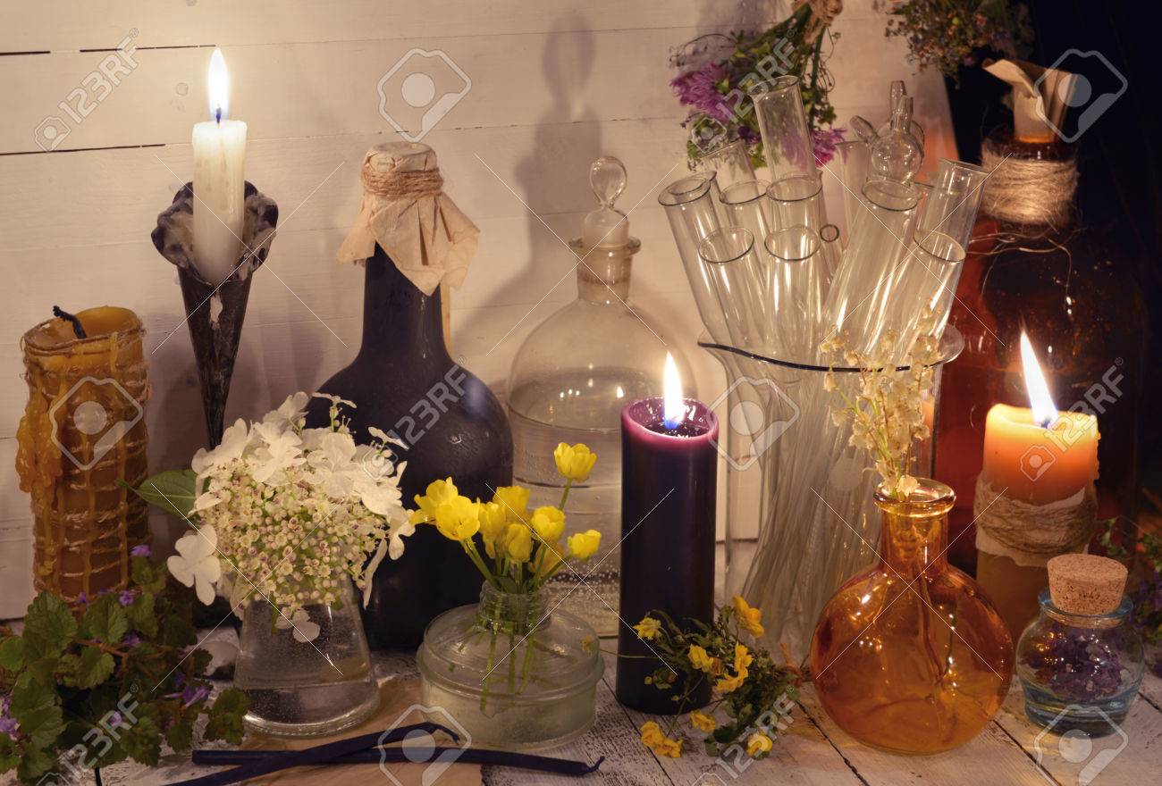 Candles, glass bottles, jars and flowers on the table. Alternative medicine, old pharmaceutic and homeopathic concept. Mystic and occult still life, vintage medical background - 82146907 Candles, glass bottles, jars and flowers on the table. Alternative medicine, old pharmaceutic and homeopathic concept. Mystic and occult still life, vintage medical background - 82146907