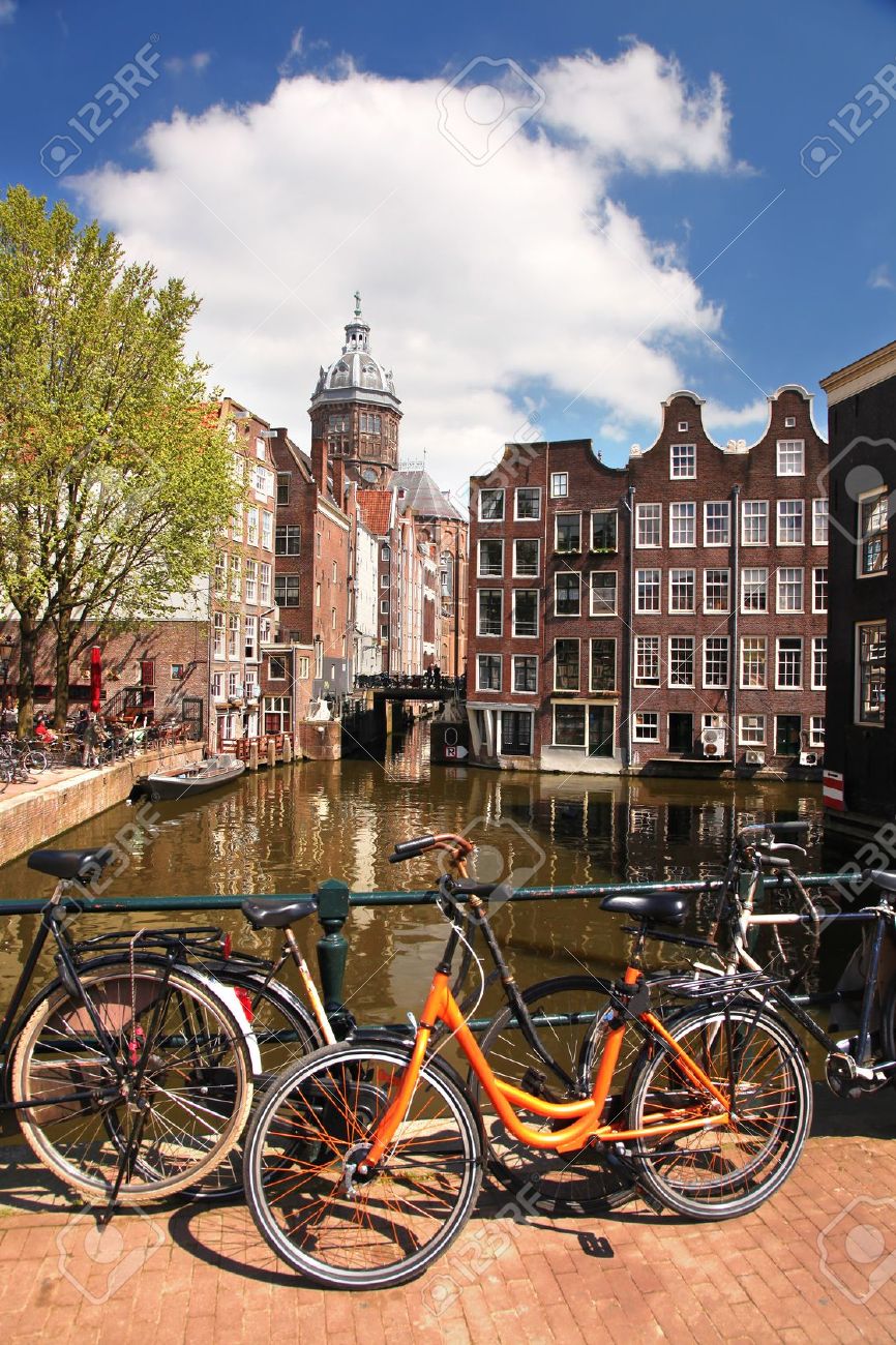 Amsterdam With Bikes On The Bridge Over Canal In Netherlands Stock