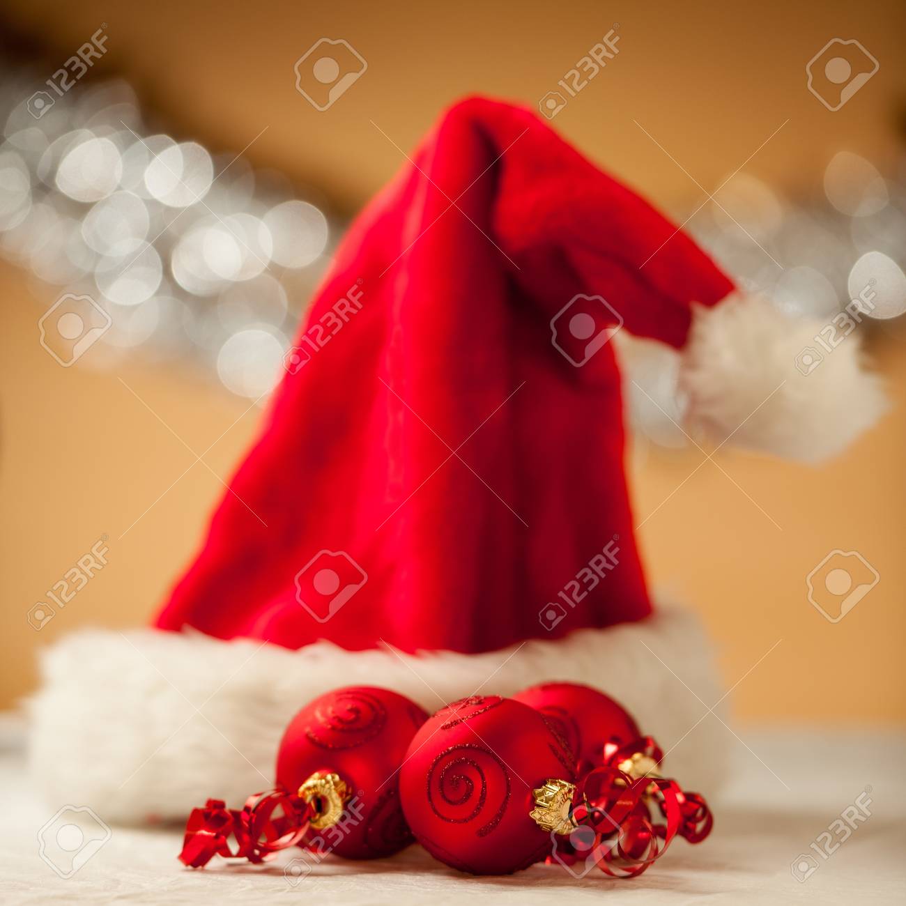 Christmas ornaments - red baubles with shiny tape in background - 16413443 Christmas ornaments - red baubles with shiny tape in background - 16413443