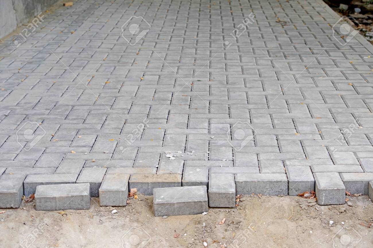 Laying Gray Concrete Paving Slabs Unfinished Work On Laying Paving Slabs Stock Photo Picture And Royalty Free Image Image 126962612