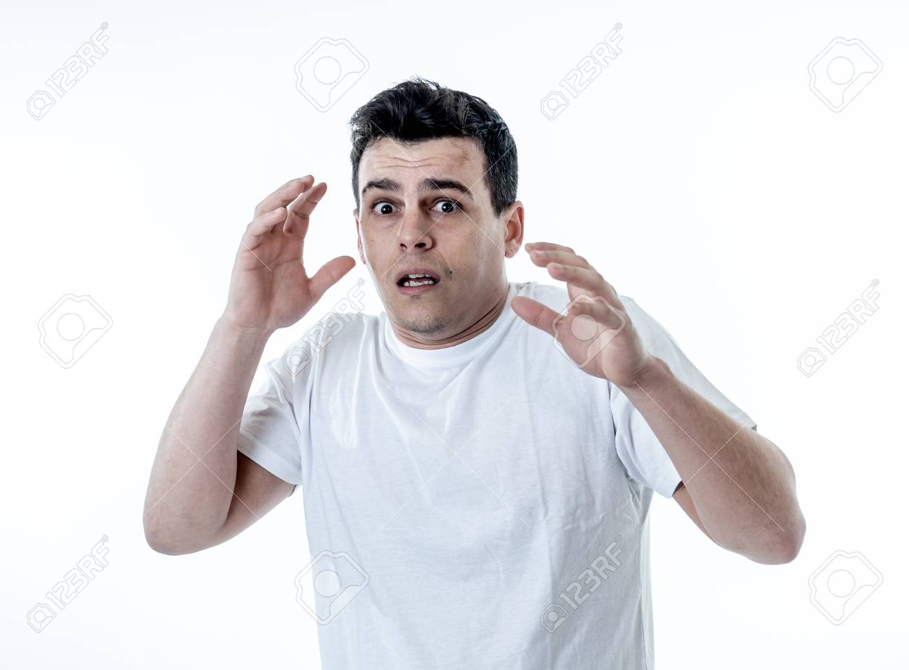 Portrait Of Young Man In Shock With A Scared Face Expression Making  Frightened Gestures In People, Human Emotions, Feelings And Horror Facial  Expression Concept. Isolated On White Background. Фотография, картинки,  изображения и