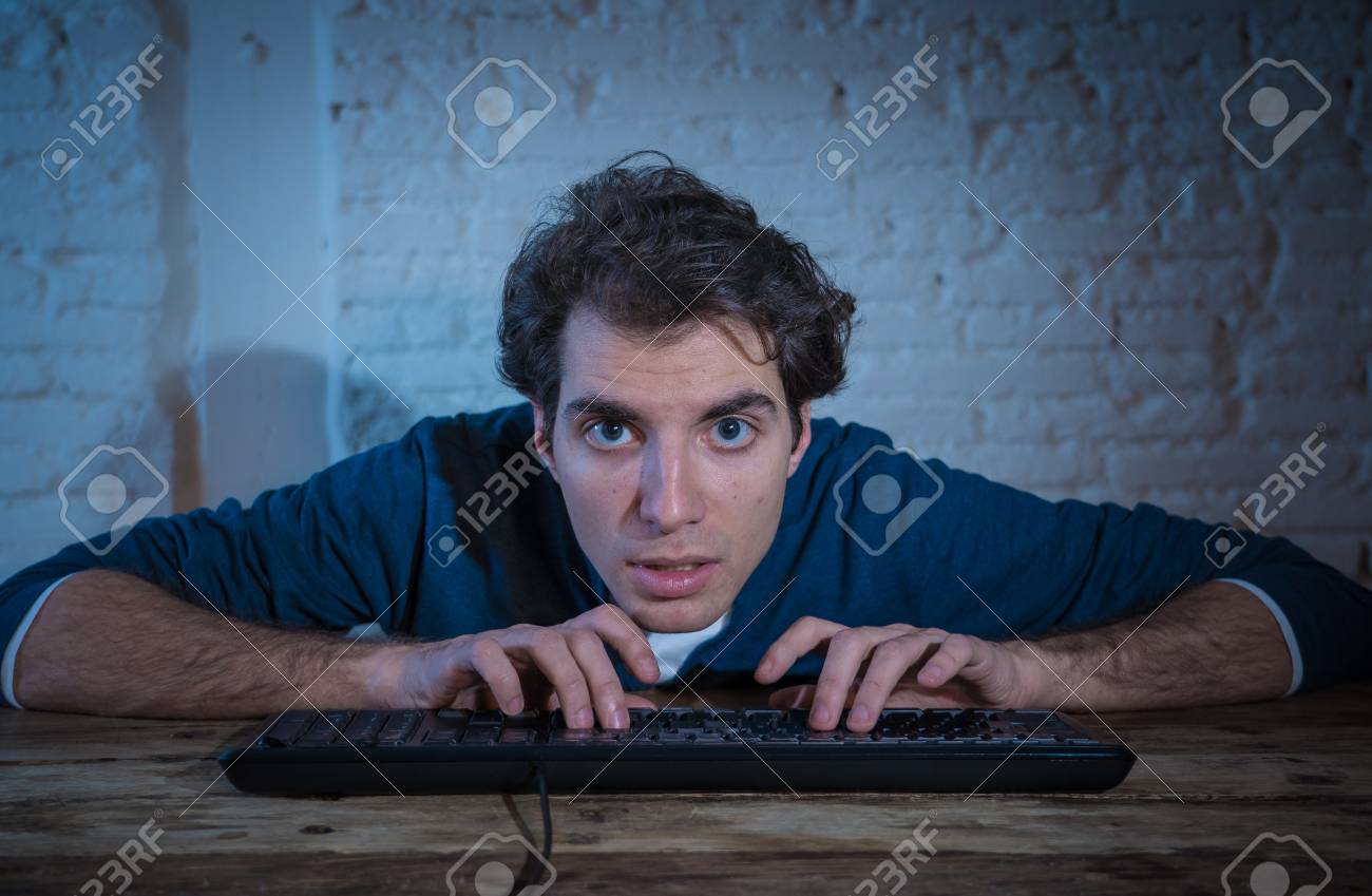 Home Porn Youngest - Addict young man alone at night on computer laptop working, online..