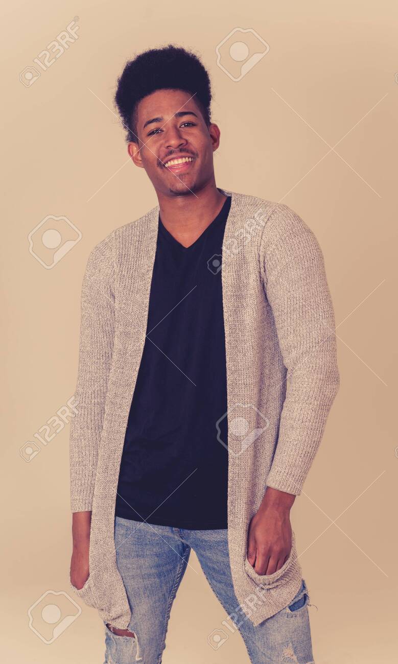 Portrait Of Attractive Stylish Young African American Teenager Man Posing  Happy Looking At The Camera With Fashion And Stylish Clothes And Afro  Hairstyle. In People Beauty And Youth Fashion Trends. Stock Photo,