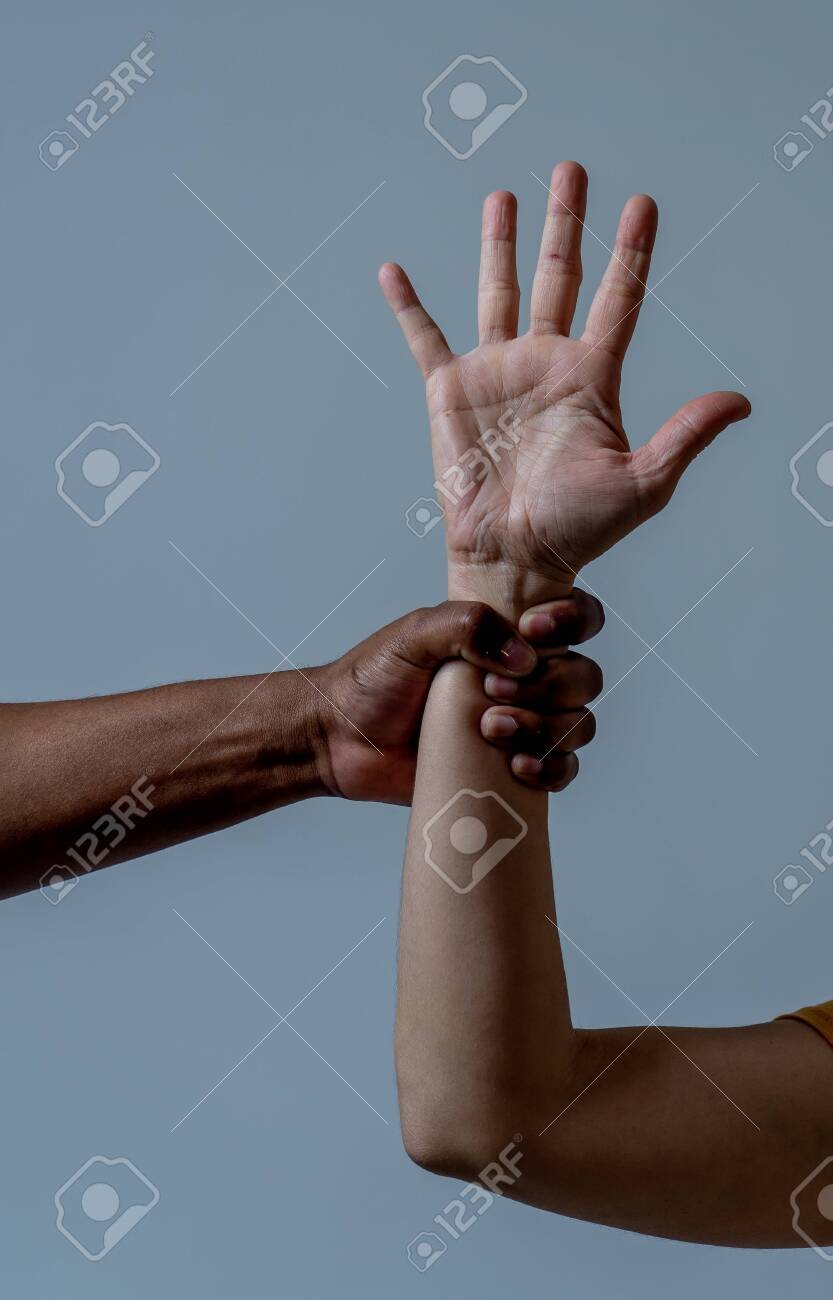 Black African American Hand Holding White Skin Arm. Conceptual Image Of  Humanitarian Campaign In Helping Refugees And Stop Racism Issues. World  Unity Cooperation Tolerance And Human Rights Concept. Stock Photo, Picture  and